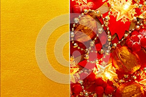 Festive Christmas golden background with red Xmas Decorations. Creative mock up for greeting card, party invitation
