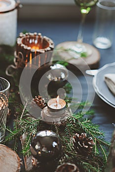 Festive Christmas and New Year table setting in scandinavian style with rustic handmade details in natural and white tones
