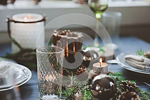 Festive Christmas and New Year table setting in scandinavian style with rustic handmade details in natural and white tones