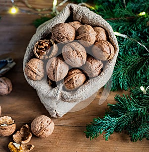 festive christmas nuts tumbling from a burlap bag