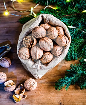 festive christmas nuts tumbling from a burlap bag