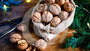 festive christmas nuts tumbling from a burlap bag