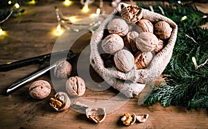 festive christmas nuts tumbling from a burlap bag