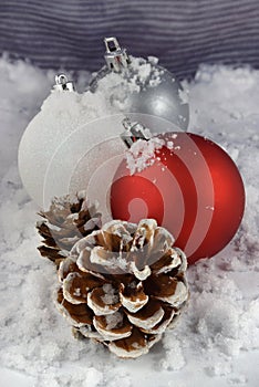 Festive Christmas Ornaments and Pine Cones Decorating a White Winter Scene