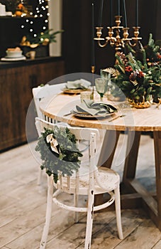 Festive Christmas table decorations. Christmas dining room. Beautiful New Year decorated home interior.