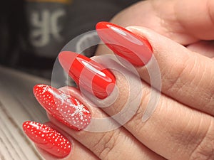 Festive Christmas-themed manicure in red shades with snowflakes