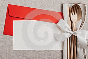 Festive christmas, wedding, birthday table setting with golden cutlery. Mockup for place card, dinner invitation