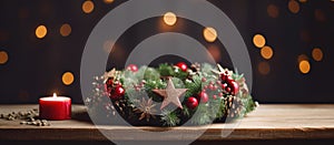 Festive Christmas wreath with red candle displayed on wooden table