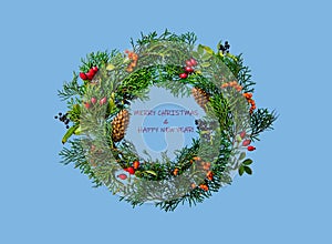 Festive Christmas wreath with rosehip, sea buckthorn, winter berry holly, mistletoe, fir and pine cones