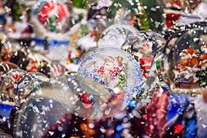 Festive cityscape - view of the Christmas decorations with Christmas crystal ball closeup on the Christmas Market