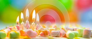 Festive colorful birthday banner with five burning candles on the cake and colorful balloons on background. Space for