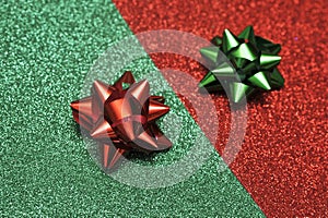 Festive colorful bows on sparkling glitter paper texture.