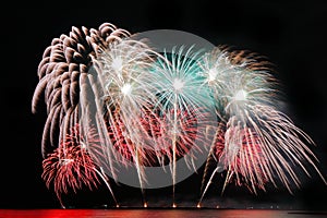 Festive colorful fireworks on night sky background. Celebratory holiday