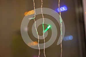 Festive colorful garland lights by the window