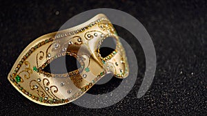 Festive  colorful Mardi Gras or carnivale mask on golden background. Venetian masks