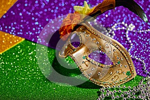 Festive, colorful Mardi Gras or carnivale mask on golden background. Venetian masks.