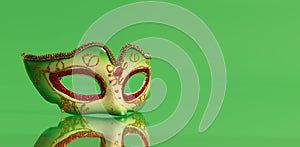 Festive, colorful masks of Mardi Gras or carnival mask on green background. Venetian