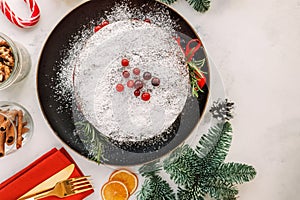 Festive composition with Christmas fruit cake and fir branch