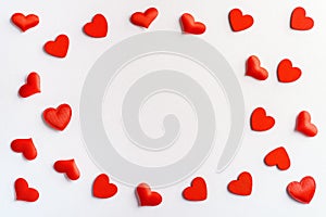 Festive composition from red hearts scattered on white background, valentines day concept, copy space for text