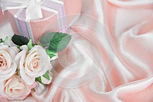 Festive composition with roses and gift box