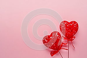 Festive composition with two red openwork white hearts on pink background. Top view, copy space. Valentine`s day concept