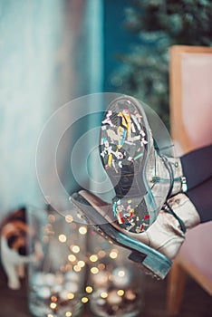 Festive confetti stuck to the sole of women`s shoes at the party