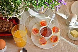 Festive continental breakfast with red caviar, soft-boiled egg a