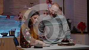 Festive couple signing christmas card for holiday festivity