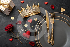 Festive creative royal table setting with crown and cutlery