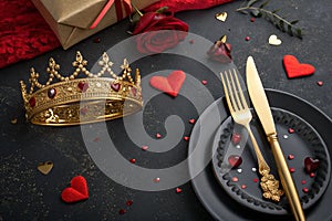 Festive creative royal table setting with crown and cutlery