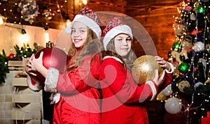 Festive decor. Santa claus little girls sisters. Little girl sisters in red hats. Wait for santa claus. Christmas time