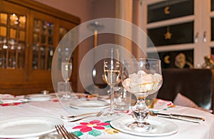Festive decorated table with an appetizer and champagne