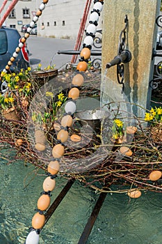 Festive decorations for Easter holiday on the village fountains of the small town of Maienfeld in the Swiss Alps