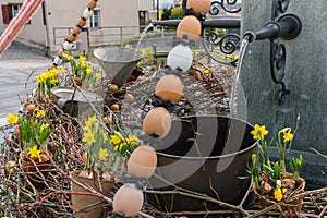 Festive decorations for Easter holiday on the village fountains of the small town of Maienfeld in the Swiss Alps