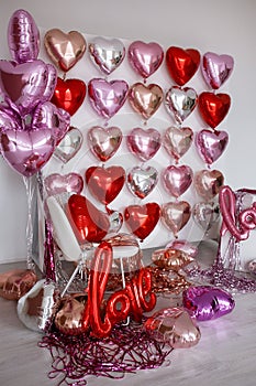 Festive decorations for Valentine's day, wedding or hen party. Love sign and heart shape balloons on white
