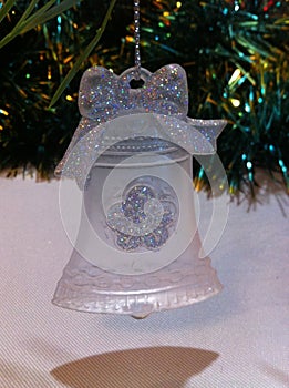 Festive decorative Christmas tree toy made of frosted glass in the form of a bell