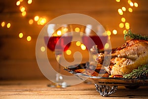 Festive dinner served on wooden table with lights background. Holiday concept