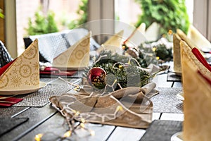 Festive dinner table setting decoration for christmas with Paper, lights