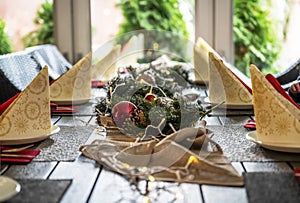 Festive dinner table setting decoration for christmas with Paper, lights