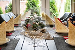 Festive dinner table setting decoration for christmas with Paper, lights