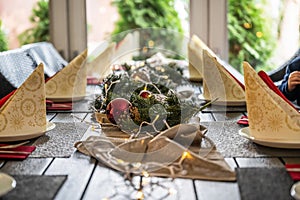 Festive dinner table setting decoration for christmas with Paper, lights