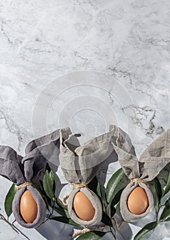 Festive easter background with Easter bunny eggs on linen napkin. Easter decoration, top view. Copy space