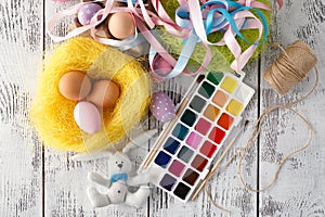 Festive easter decoration on white table with pastel color eggs