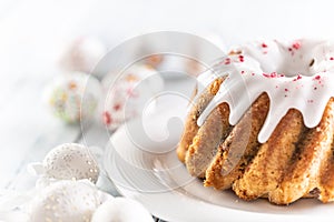 Festive easter marble cake with icing sugar with hand-decorated eggs