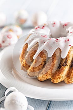 Festive easter marble cake with icing sugar with hand-decorated eggs