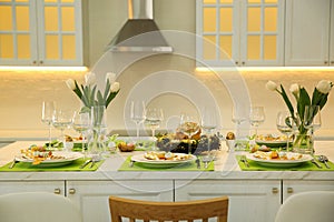 Festive Easter table setting with decor in kitchen