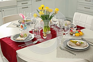 Festive Easter table setting with decor in kitchen