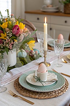 Easter table setting with candle and flowers