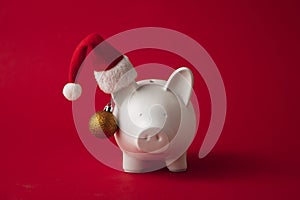 Festive financial savings concept. Piggy bank with Christmas decorations