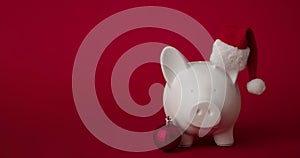 Festive financial savings concept. Piggy bank with Christmas decorations